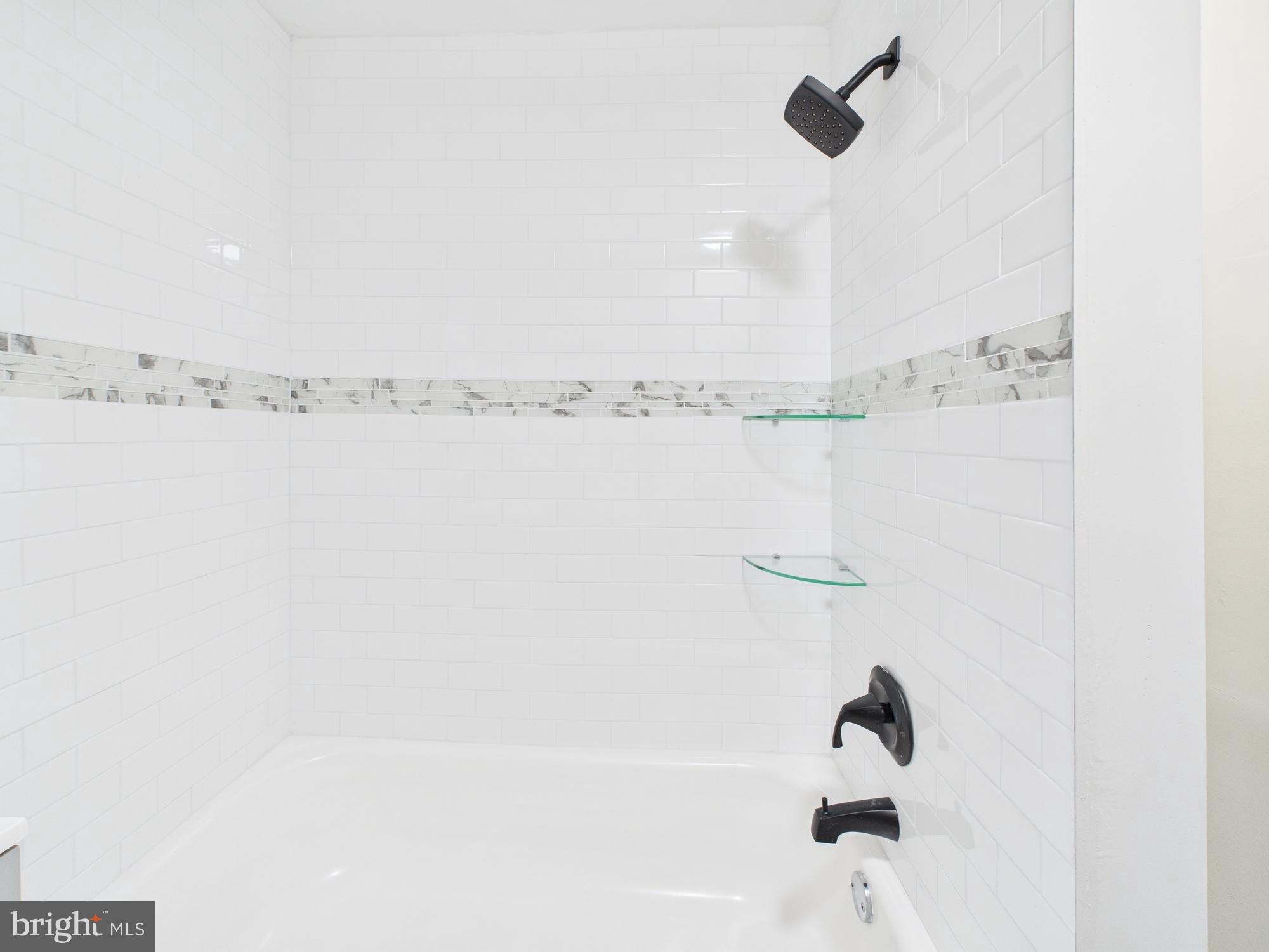 11 Denham Avenue Claymont, DE 19703 - Photo 18 of 28 Sleek, modern shower with elegant tile accents.