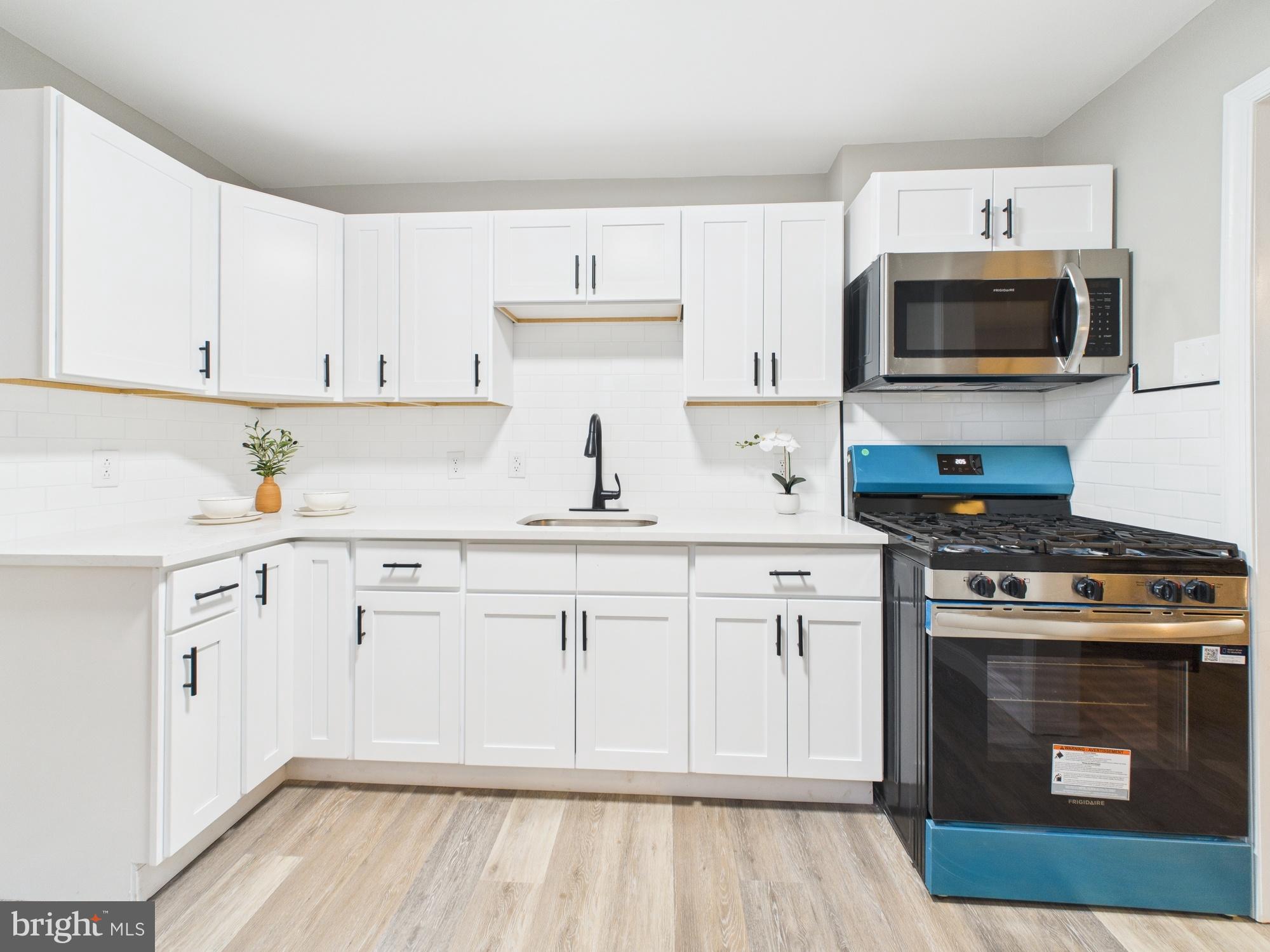 11 Denham Avenue Claymont, DE 19703 - Photo 2 of 28 Modern kitchen with sleek white cabinetry.