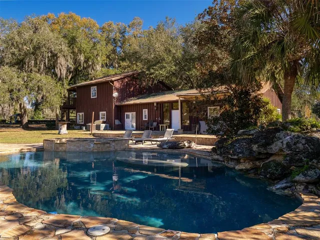 a view of house with yard outdoor seating and barbeque oven