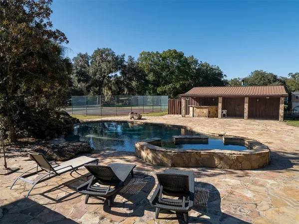 a view of a backyard with swimming pool