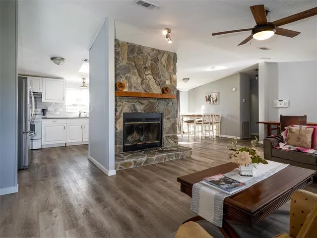 a kitchen with granite countertop white cabinets and white appliances