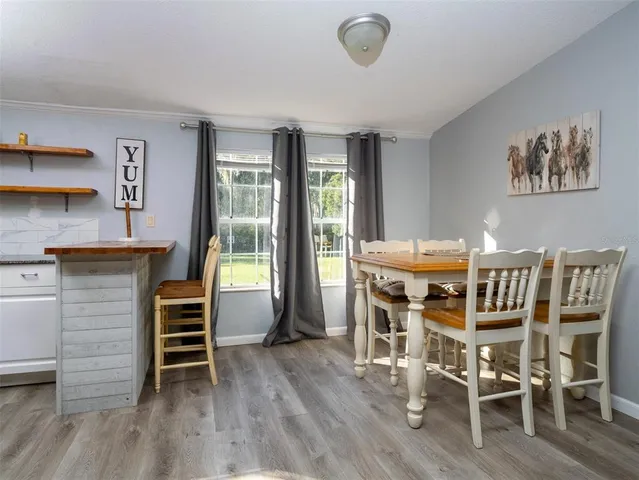 a kitchen with stainless steel appliances a refrigerator stove and wooden floor