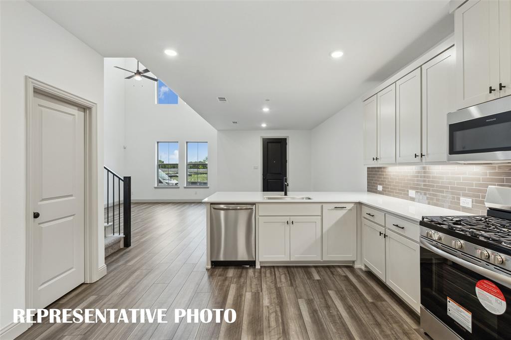 1021 Magdalena Way Midlothian, TX 76065 - Photo 5 of 16 The kitchen peninsula with breakfast bar makes this the perfect place to grab a quick bite. REPRESENTATIVE PHOTO