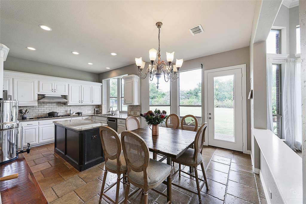 671 Countryside Drive Fairview, TX 75069 - Photo 11 of 36 a view of a dining room with furniture a chandelier and wooden floor