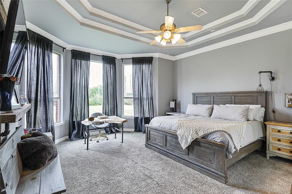 671 Countryside Drive Fairview, TX 75069 - Photo 15 of 36 a bedroom with a bed and a chandelier