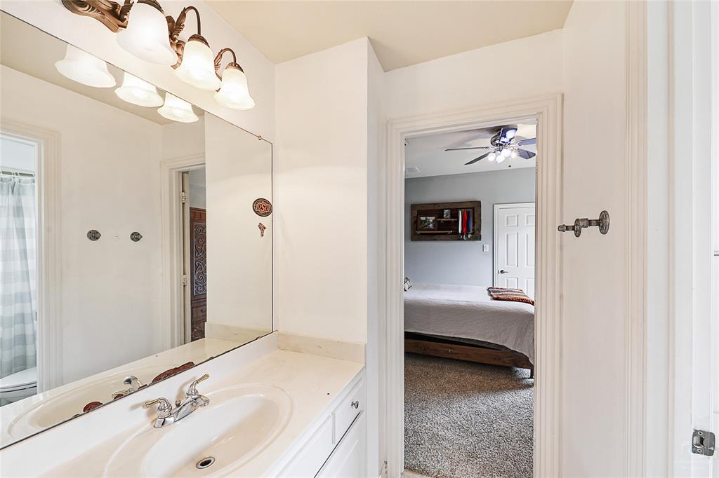 671 Countryside Drive Fairview, TX 75069 - Photo 30 of 36 a en suite bathroom with a sink and a mirror