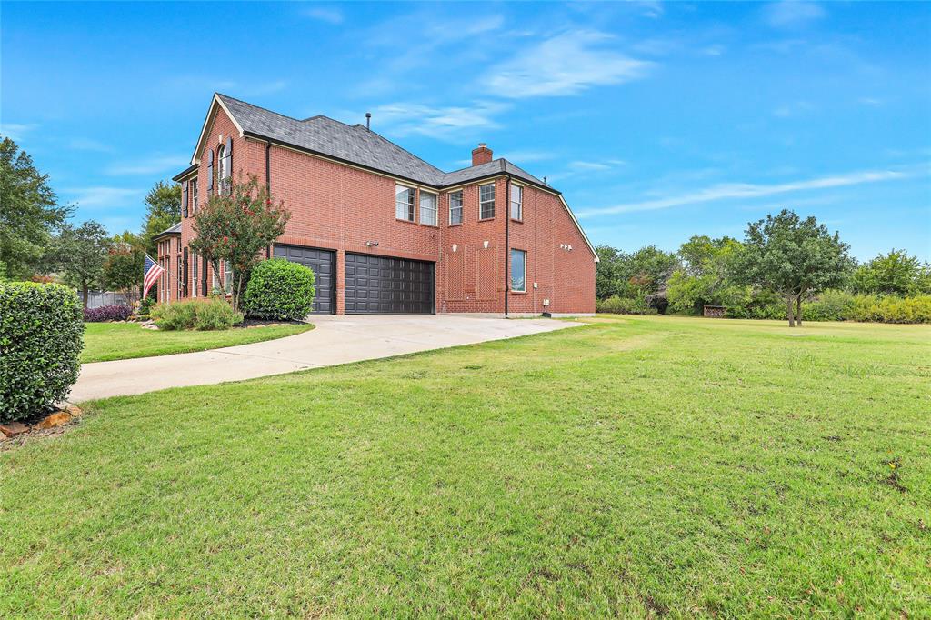 671 Countryside Drive Fairview, TX 75069 - Photo 36 of 36 a front view of a house with a yard and garage
