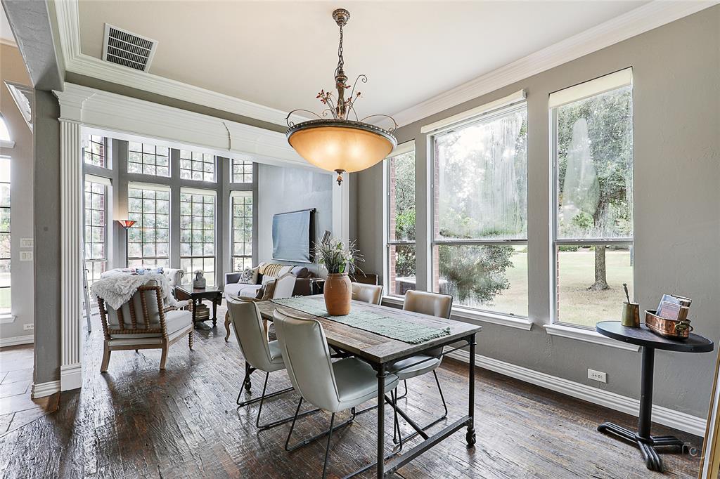 671 Countryside Drive Fairview, TX 75069 - Photo 4 of 36 a dining room with wooden floor and a chandelier