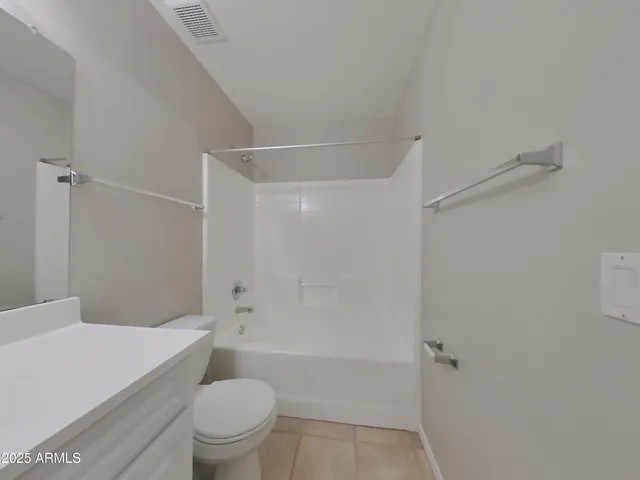 a spacious bathroom with a sink and a mirror