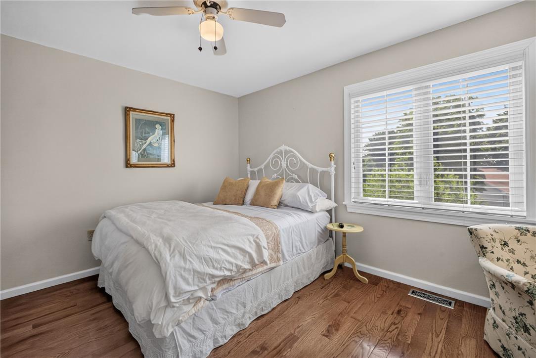 6467 Abbey Road Wind Gap, PA 18091 - Photo 34 of 46 Hardwood floors and a large window illuminate this inviting bedroom, perfect for restful nights.