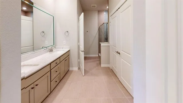 a bathroom with a double vanity sink and mirror