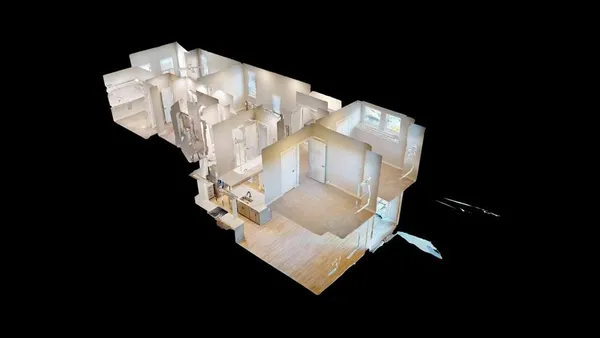 a white vase with flowers sitting on a table