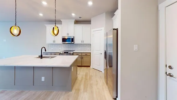 a kitchen with a sink and a refrigerator