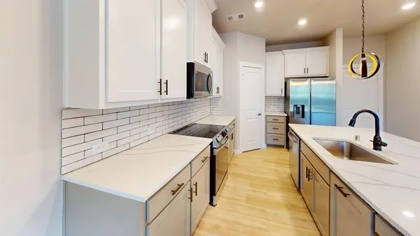 a kitchen with a sink and a refrigerator