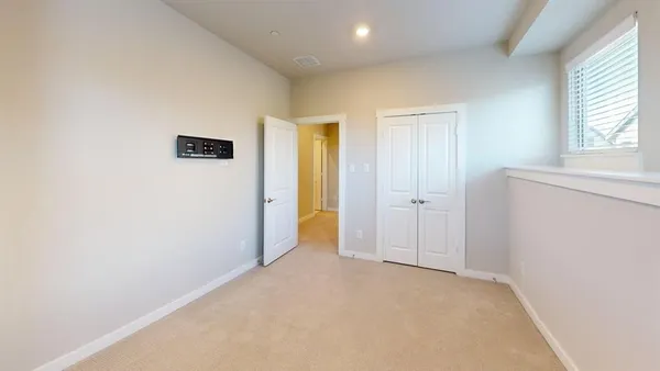 an empty room with windows and closet