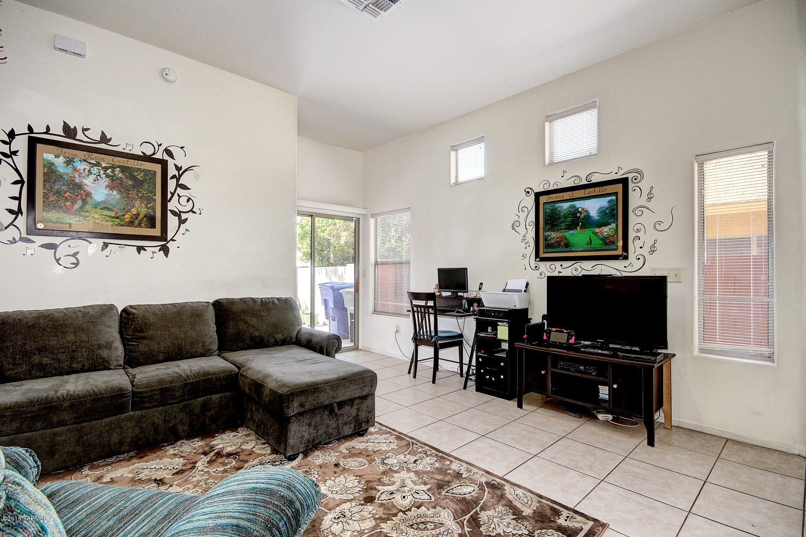 6016 South Avenida Ribero Tucson, AZ 85706 - Photo 3 of 15 a living room with furniture and a flat screen tv