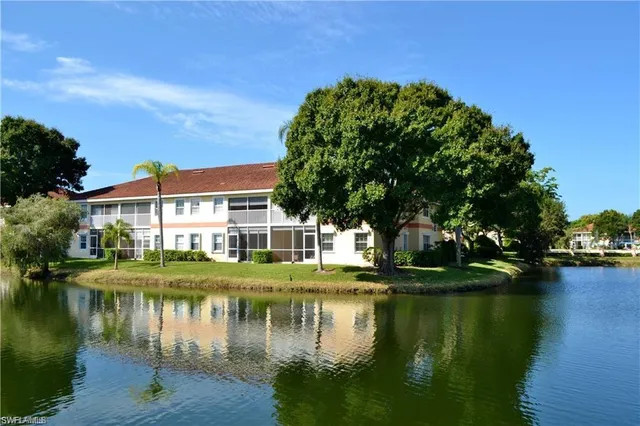 a view of residential house with outdoor space and lake view