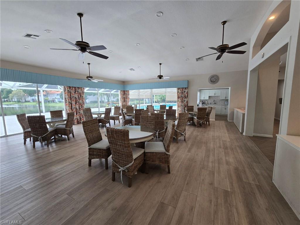 7436 Plumbago Bridge Road, Unit N202 Naples, FL 34109 - Photo 19 of 24 a view of a dining room with furniture window and wooden floor