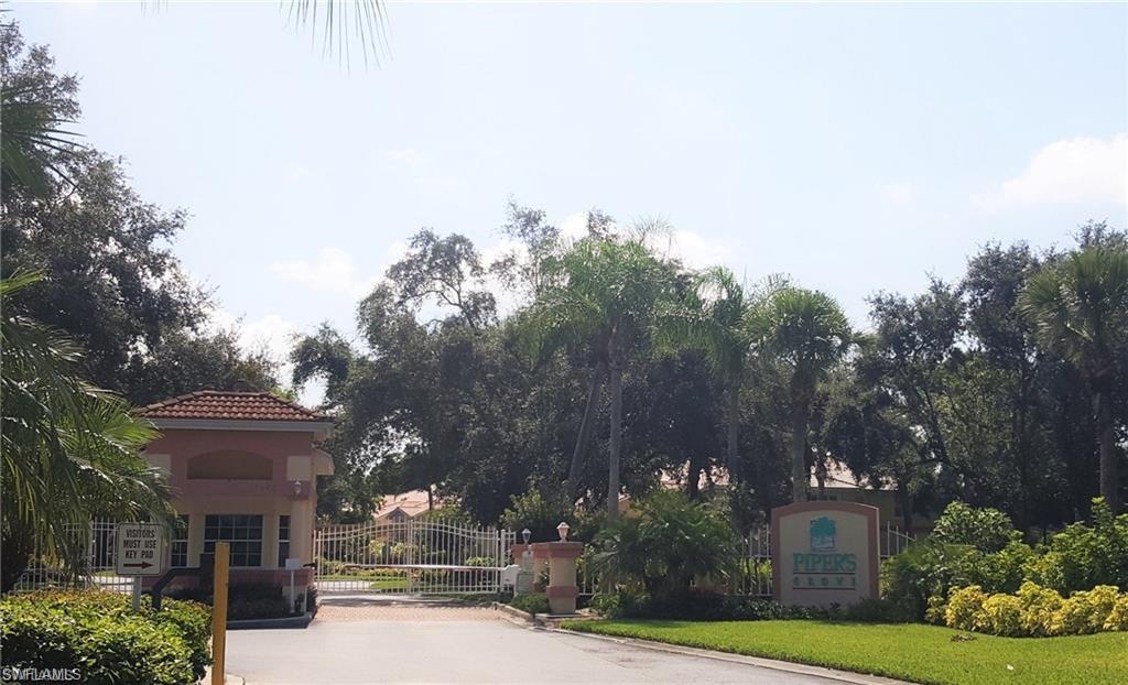 7436 Plumbago Bridge Road, Unit N202 Naples, FL 34109 - Photo 24 of 24 a front view of a house with a yard and garage
