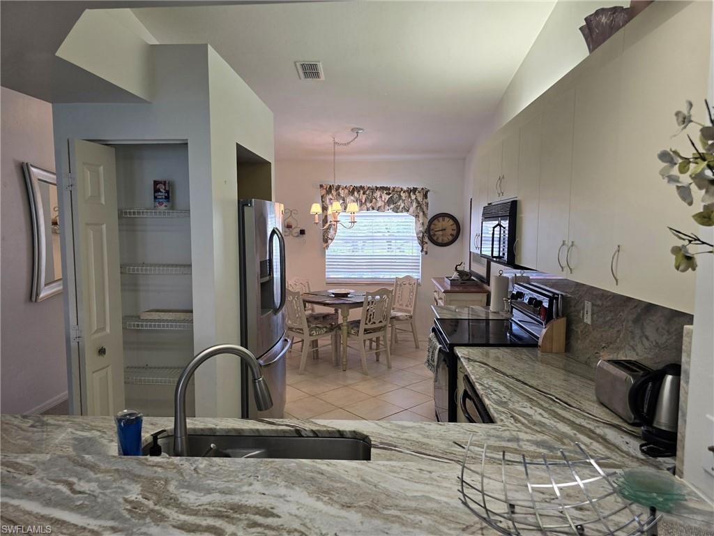 7436 Plumbago Bridge Road, Unit N202 Naples, FL 34109 - Photo 4 of 24 a view of a living room and dining room