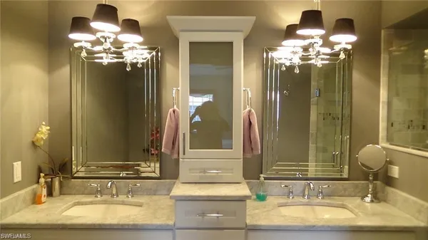 a bathroom with a double vanity sink and a mirror