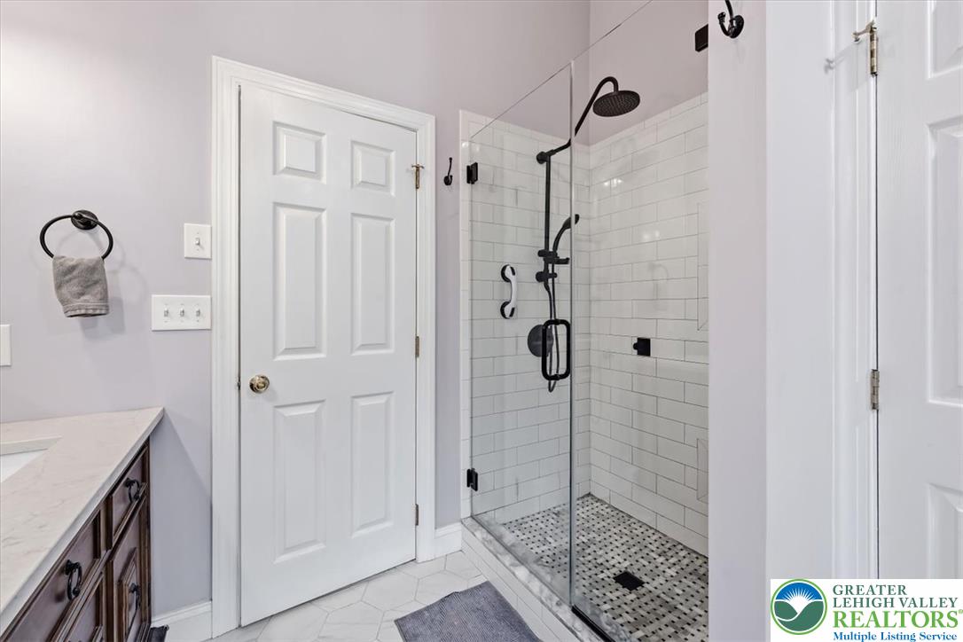 2011 Fieldview Drive Nazareth, PA 18064 - Photo 25 of 52 A sleek, contemporary shower with subway tile walls and black fixtures awaits in this refined bathroom.