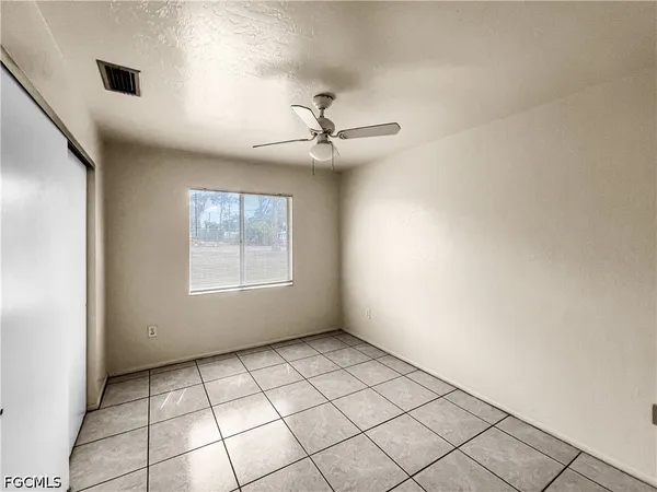 a view of an empty room with a window
