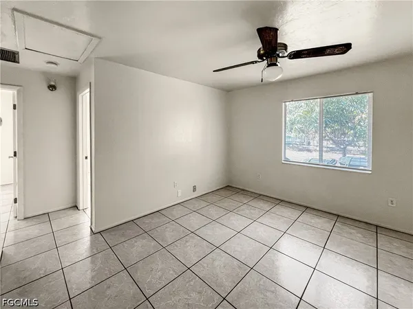 a view of an empty room and a window