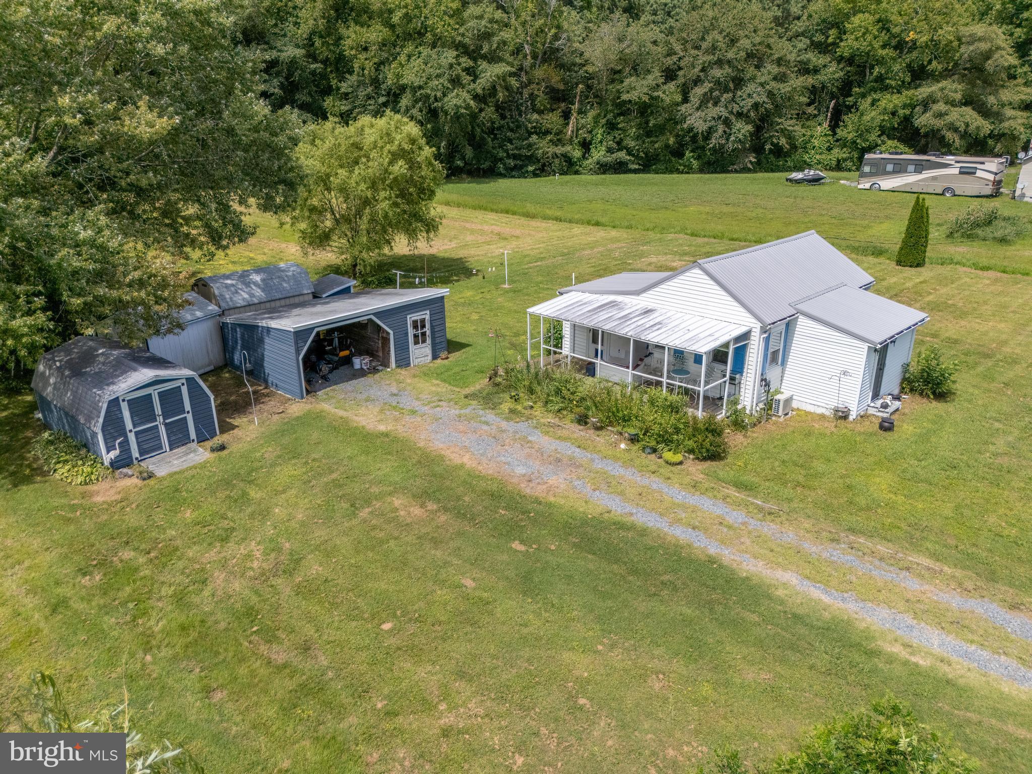 7821 Libertytown Road Berlin, MD 21811 - Photo 6 of 9 an aerial view of a house with garden space and a yard