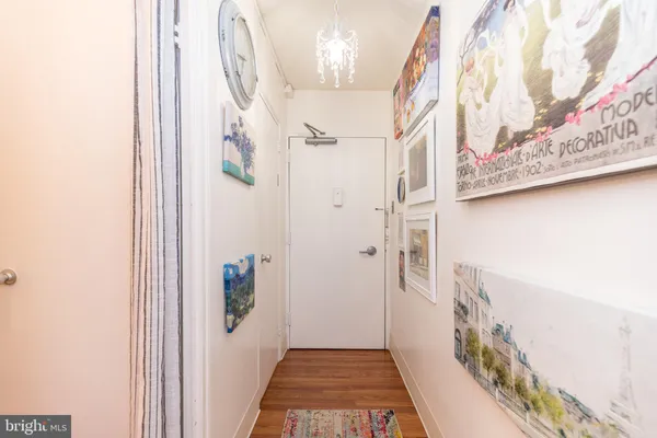 a view of a hallway with wooden floor and entryway