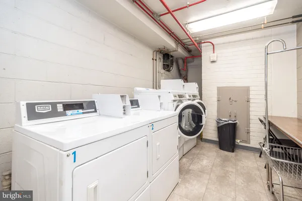 a utility room with sink dryer and washer