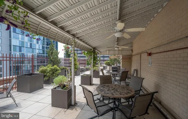 a view of an outdoor dining space with a table and chairs