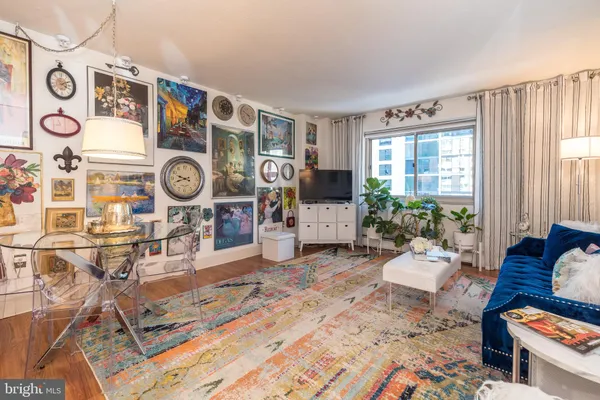a living room filled with furniture and a clock