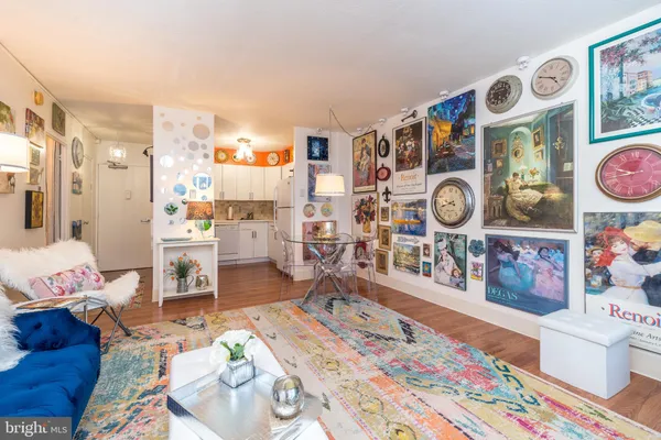 a living room with furniture and painting on the wall