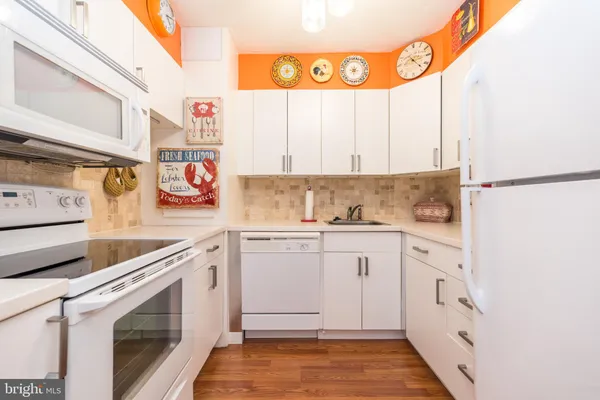 a kitchen with stainless steel appliances granite countertop a refrigerator and a stove