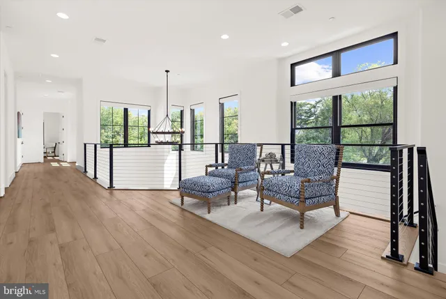 a living room with furniture and large windows