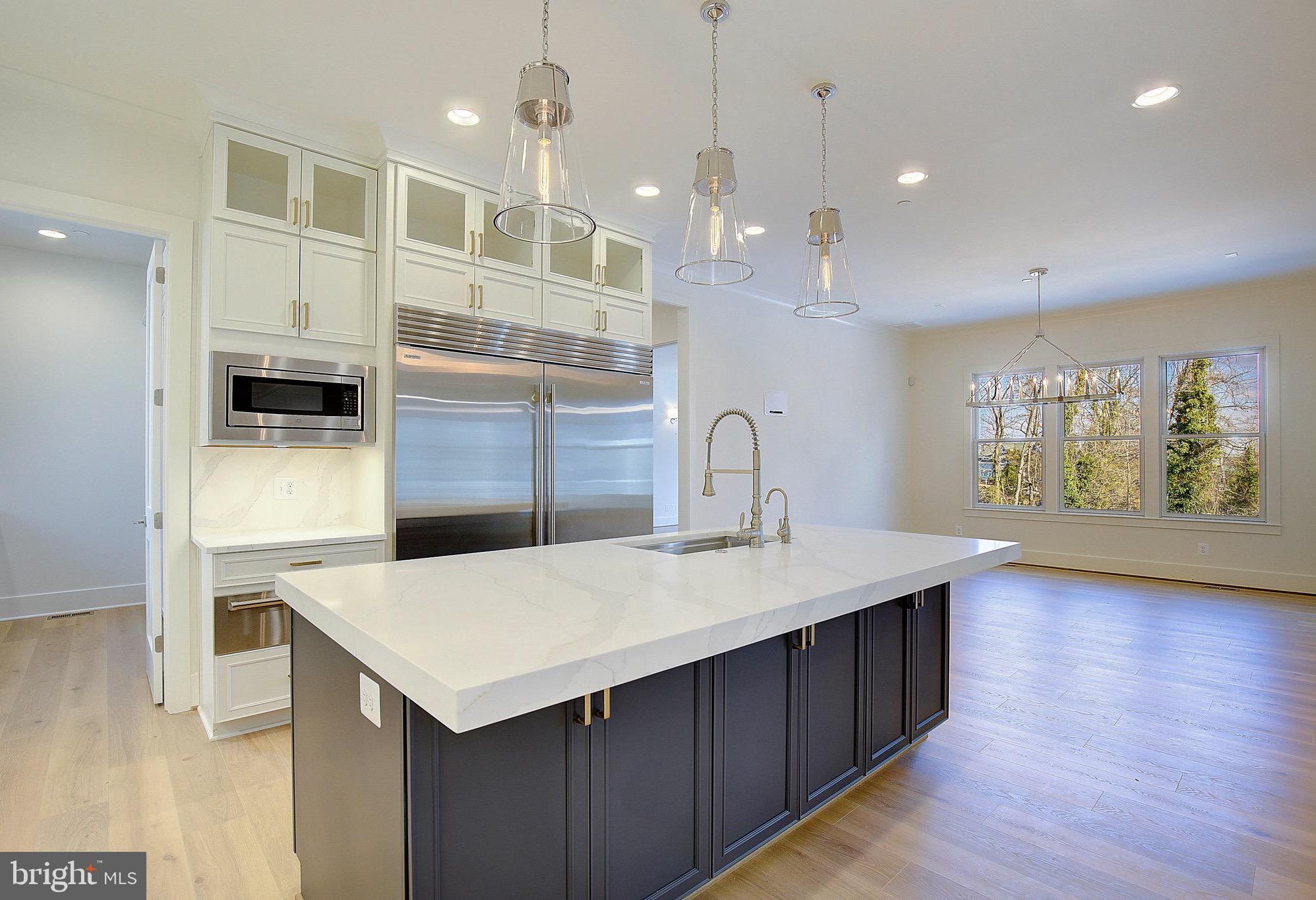 12606 Newgate Road Rockville, MD 20850 - Photo 28 of 43 a kitchen with a kitchen island a sink stainless steel appliances and cabinets
