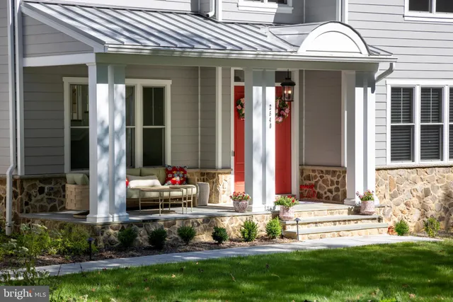 a front view of a house with a garden and plants
