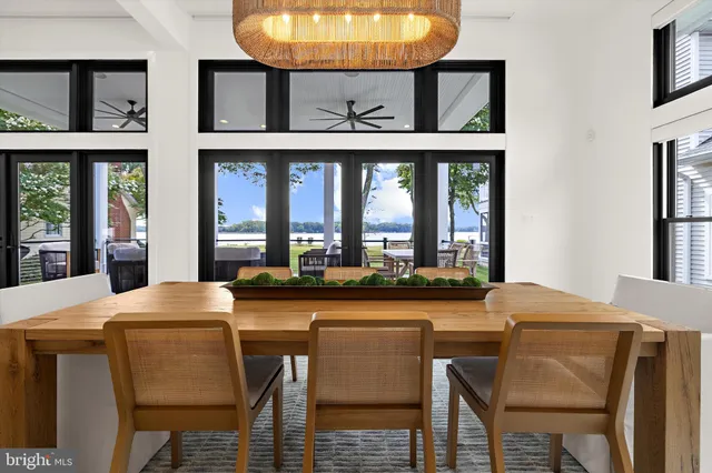 a dining room with furniture a rug and a large window