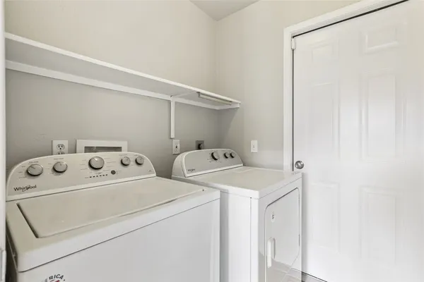 an empty room with windows and fireplace