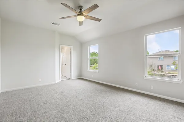a view of a hallway with white walls and stairs
