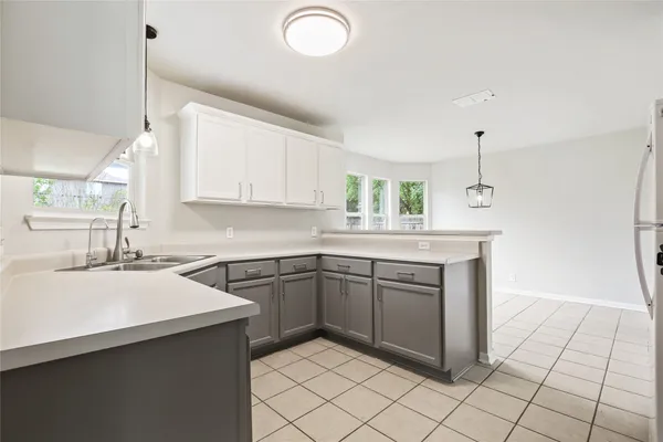 a kitchen with cabinets stainless steel appliances and a wooden floor