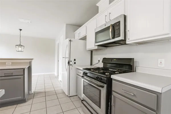 a kitchen with stainless steel appliances granite countertop a sink a stove a refrigerator and cabinets