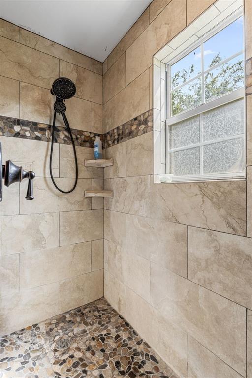 13315 Highway 281 Scotland, TX 76379 - Photo 20 of 40 Remodeled shower enclosure featuring stone-look tiles