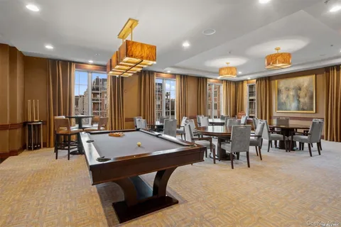 a living room with chairs a table and chairs