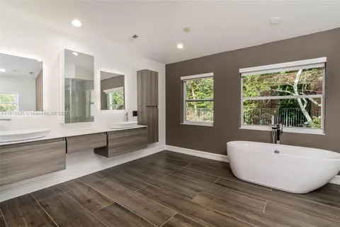 a large kitchen with a large counter top stainless steel appliances and cabinets