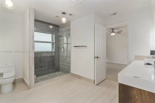 a bathroom with a shower and a toilet