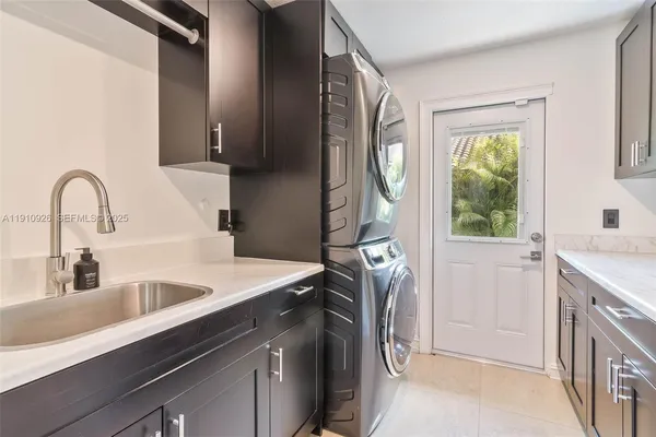 a kitchen with a sink cabinets and a window