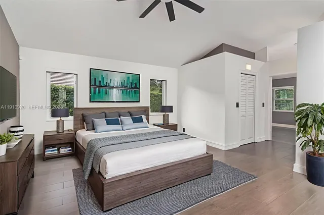 a bedroom with a bed a couch and a window