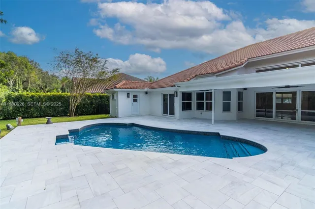 a view of a house with swimming pool and a yard